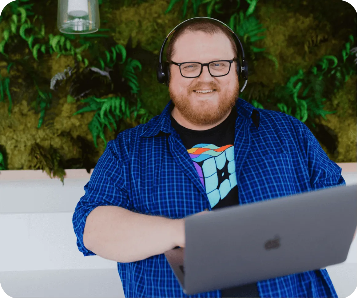 WP Engine customer support representative holding laptop and smiling