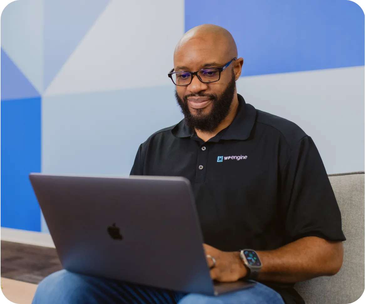 WP Engine employee looking at laptop screen