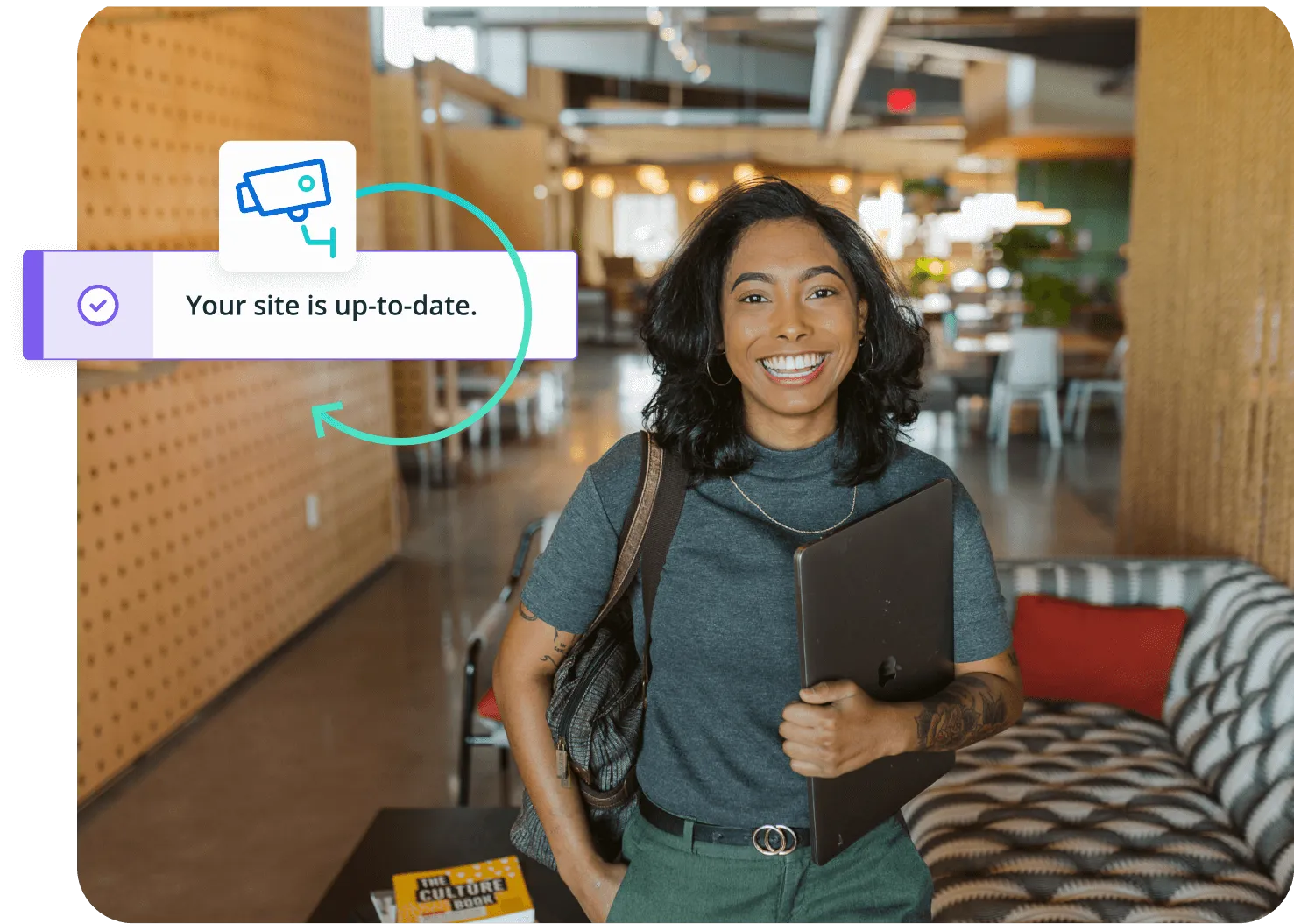 woman holding laptop in office setting