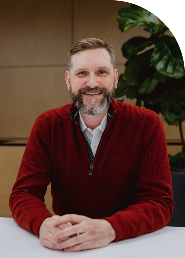 man smiling with hands clasped