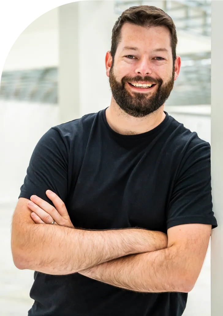 Man smiling next to WordPress monitoring platform